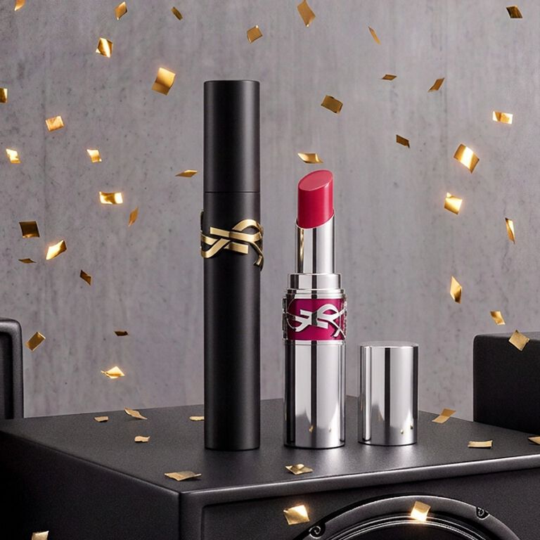 Pre-Black Friday teaser featuring YSL Mascara Lash Clash Volume Extreme and Loveshine Candy Glaze on a black display with gold confetti.