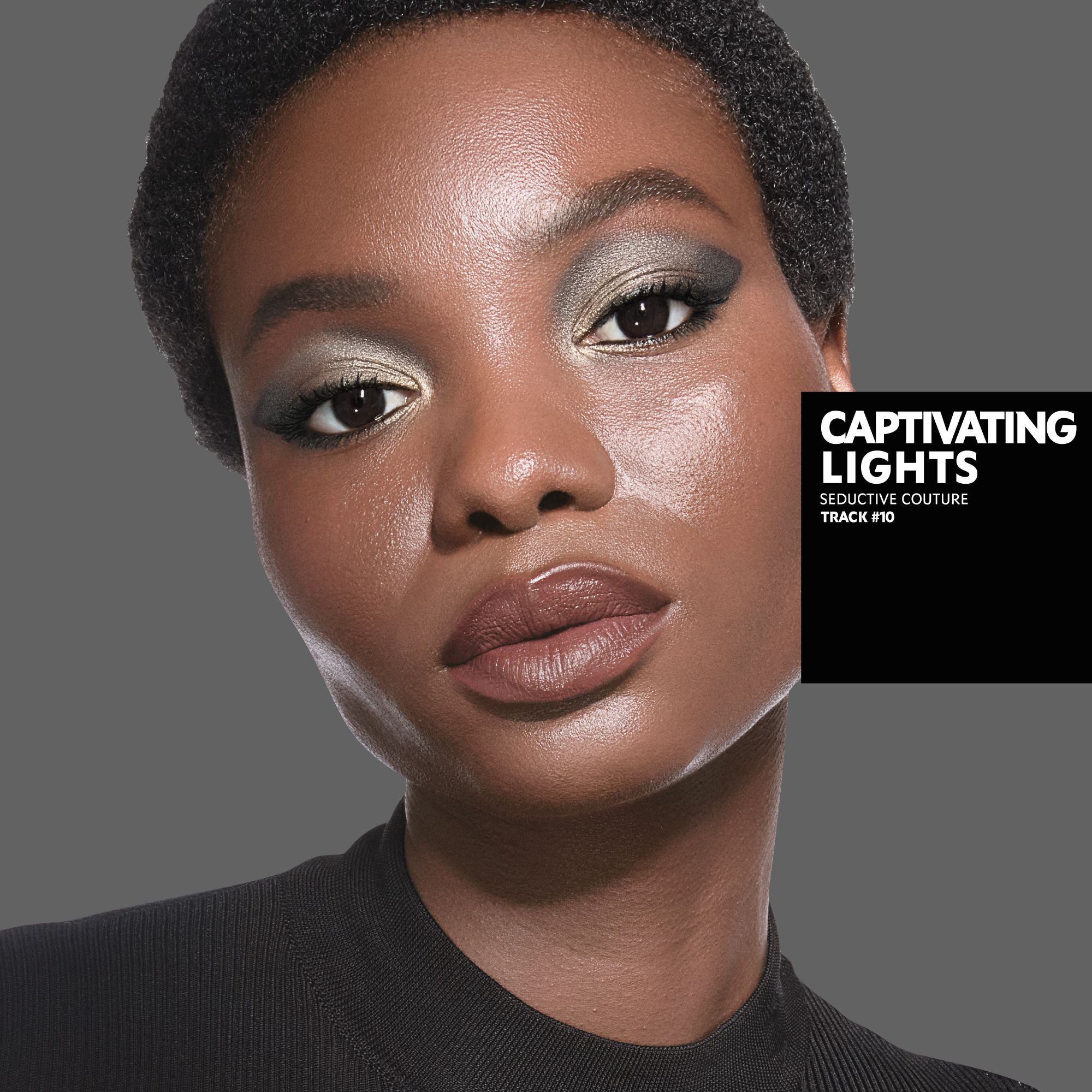 Marie, dark skin tone, with a seductive couture captivating lights eye look and matte brown lips, wearing a black top.