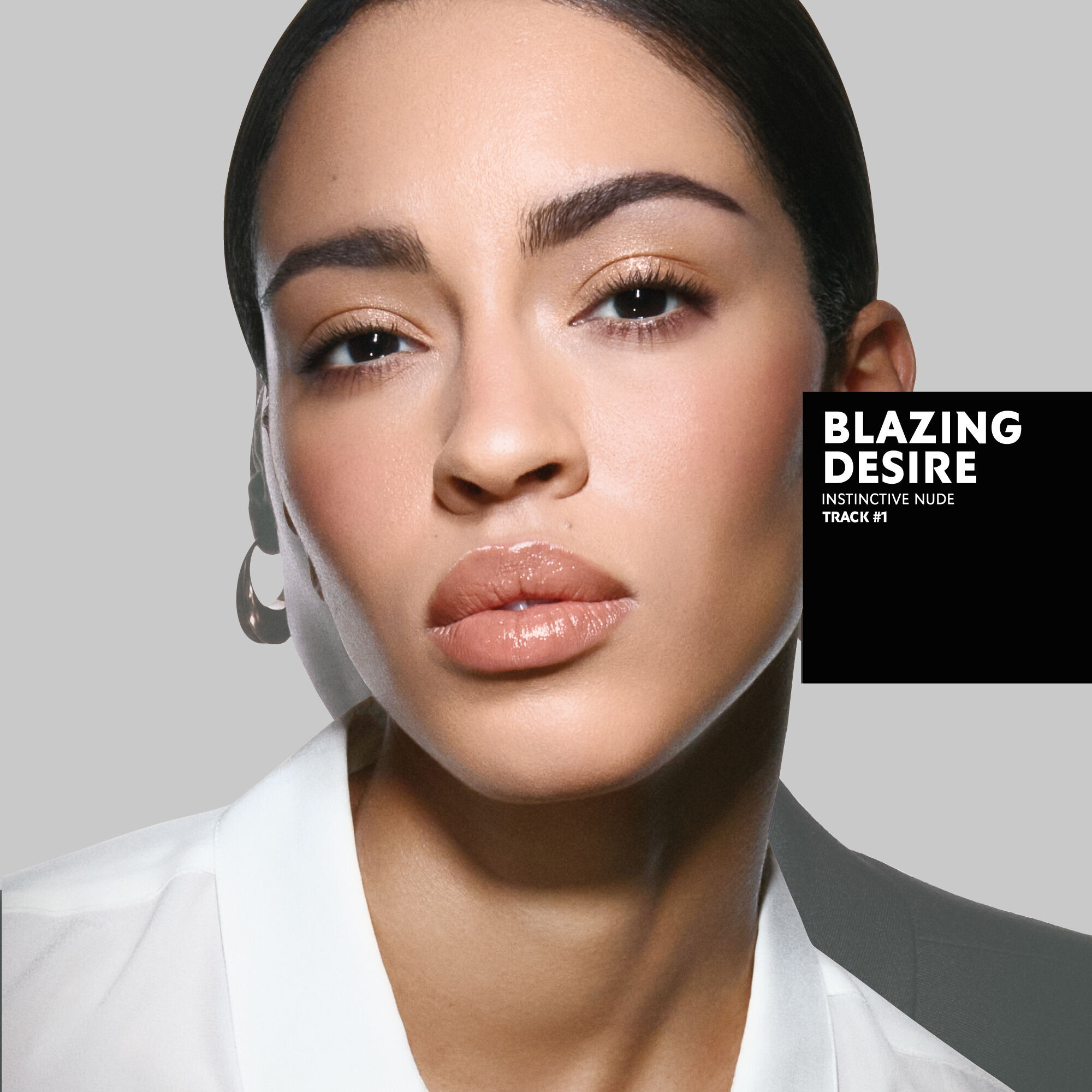 Karen, tanned skin tone, with an instinctive nude eye look and blazing desire glossy lips, wearing a white top.