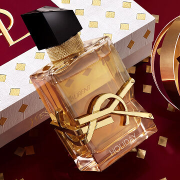 YSL LIBRE Eau de parfum alongside iconic gold and burgundy Holiday gift packaging.