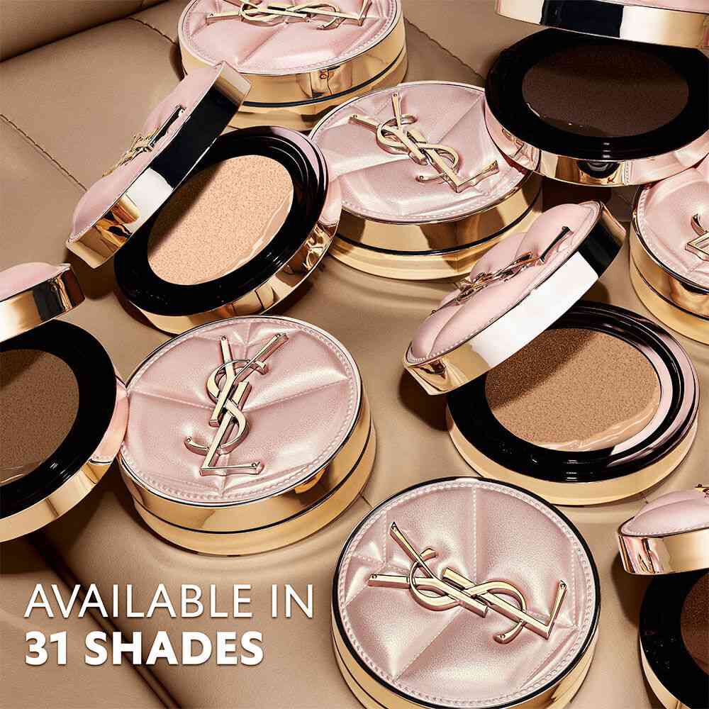 Multiple YSL SKIN AFFAIR CUSHION cases in a pool of liquid foundation. Luxury pink quilted design and gold logo.