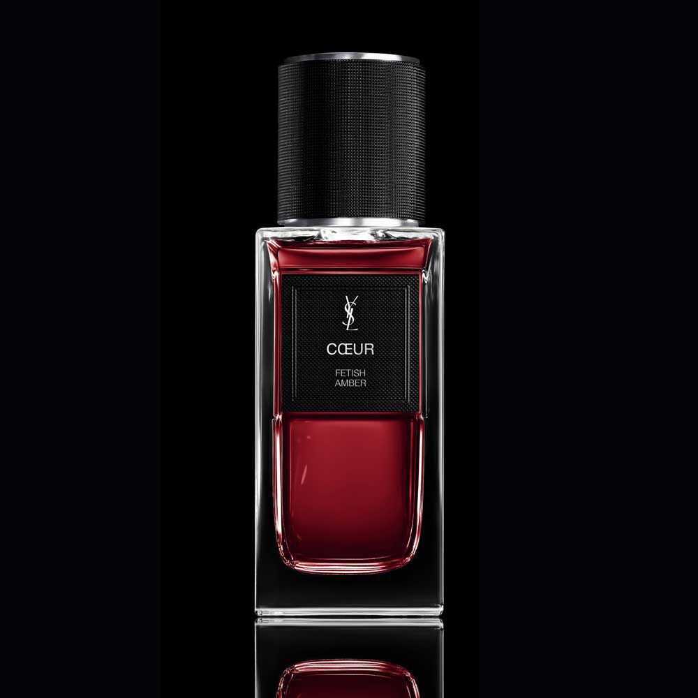 COEUR Eau de Parfum ruby-red bottle with black cap on a reflective YSL background.