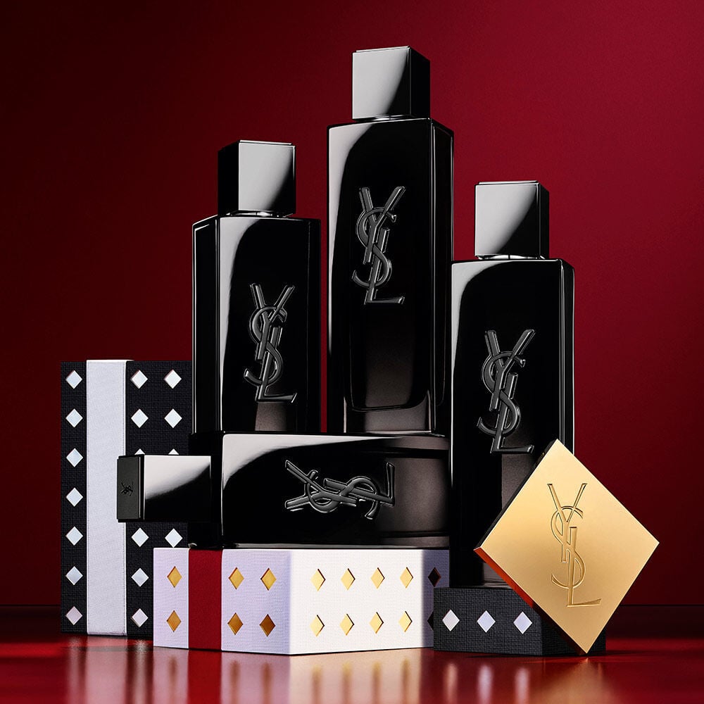YSL MYSLF Eau de Parfum bottles stacked on black and silver patterned Holiday gift boxes.