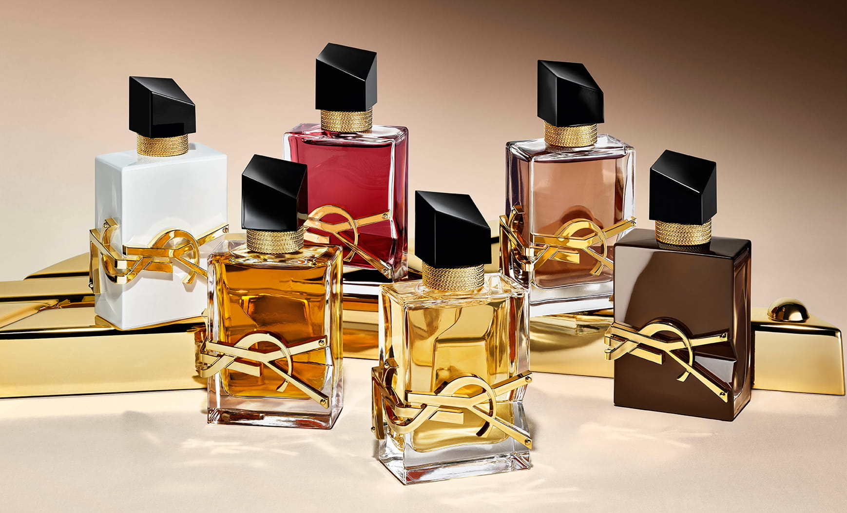 Collection of Libre fragrance bottles including the new glazed brown Libre Santal Couture.