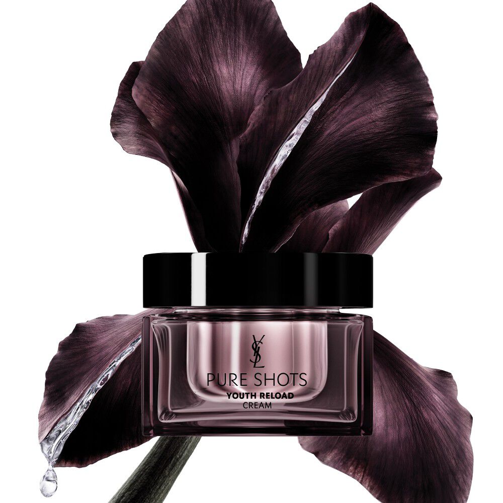 YSL Beauty Pure Shots Youth Reload cream jar, elegantly positioned in front of a dark purple iris flower.