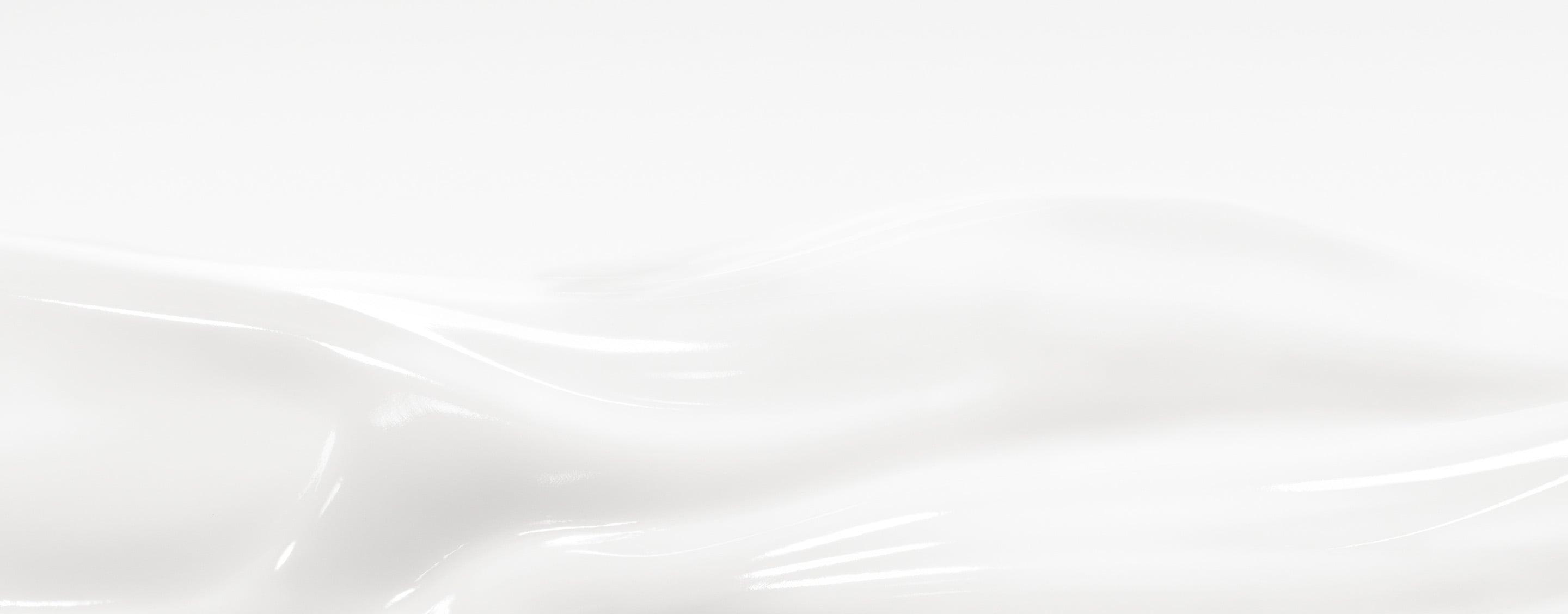 Macro of silky white Care Crush cream texture forming smooth waves.